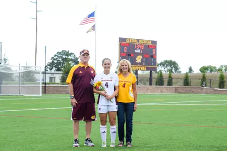 CMU senior Christie Chiesa (center) stands with her parents, Jack and Janice, Sunday during Senior Day at the CMU Soccer-Lacrosse Field.