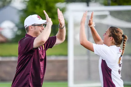 CMU coach Peter McGahey (left) high-fives Kaylin Hoomaian after Sunday's 1-0 win over Oakland. The Chippewas improved to a program-best 8-0-0 with the win.