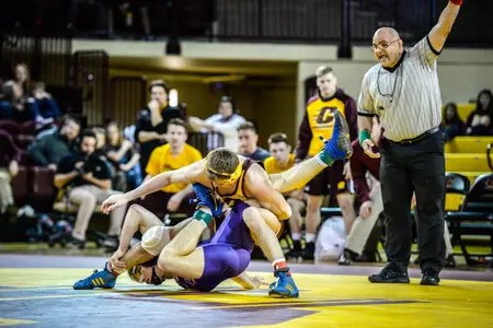 CMU freshman Mason Smith (top) battles Northern Iowa's Jake Hodges in the 141-pound match on Sunday at McGuirk Arena. Smith won in overtime, 6-4.