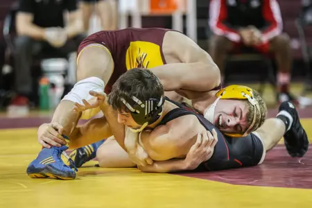 CMU freshman Mason Smith works to turn NIU's Anthony Rubino during their 141-pound match on Sunday at McGuirk Arena. Smith won on a first-period pin.