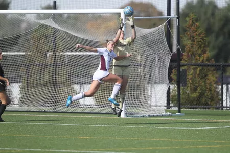 CMU's Lexi Pelafas tries to get to the ball in front of Western Michigan goalkeeper Stephanie Heber on Sunday at the CMU Soccer Complex.