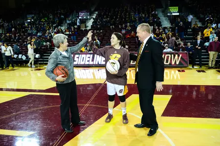 CMU coach Sue Guevara high-fives junior guard Presley Hudson after the pair were presented commemorative balls by CMU Associate Vice President/Director of Athletics Michael Alford (right) prior to CMU's game against College of Charleston on Friday at McGuirk Arena. Guevara notched her 300th career coaching victory earlier this week in the Chippewas' win over Vanderbilt, and Hudson surpassed the 1,000 career point mark in the Chippewas' season-opening game against Purdue.