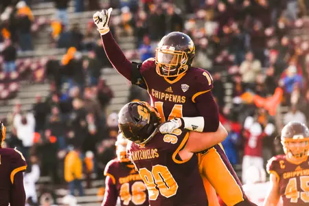 CMU safety Josh Cox gets a lift from teammate Chris Kantzavelos after Cox clinched CMU's win on Friday with a late interception. Cox and Kantzavelos are part of a senior class that has left a lasting legacy on the CMU program.