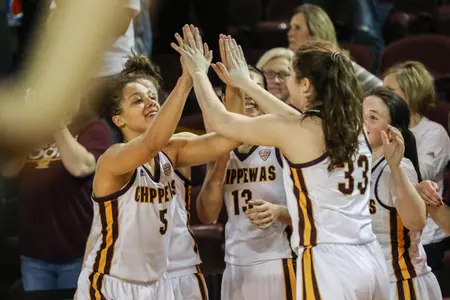 CMU's Aleah Swary (5) and Gabrielle Bird high-five after the Chippewas rolled past Northern Illinois on Wednesday at McGuirk Arena.