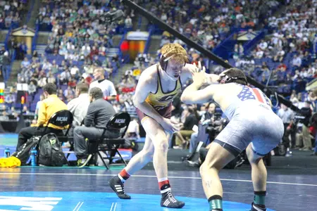 Central Michigan sophomore Justin Oliver (left) battles Virginia Tech's Solomon Chishko on Friday at the NCAA Championships at Scottrade Center in St. Louis.