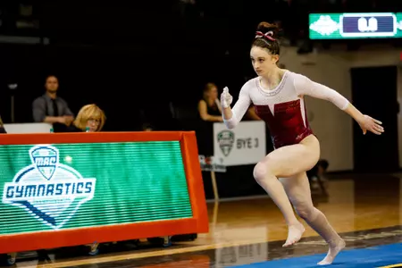 CMU junior Macey Hilliker salutes the crowd after receiving her gold medal for placing first on the floor exercise Saturday at the MAC Championships at Bowling Green's Stroh Center.