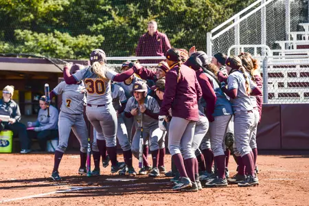 CMU's Erika Underwood (30) finishes her home-run trot as teammates await Wednesday in the Chippewas' 3-1 nonconference win over Oakland at Margo Jonker Stadium.