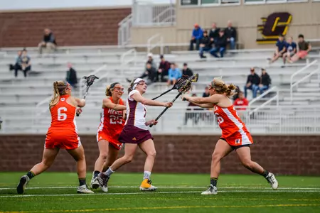 CMU's Jocelyne Lemay tussles with a pair of Mercer players on Friday during an Atlantic Sun lacrosse game at the CMU Lacrosse-Soccer Stadium. Lemay scored five goals in the Chippewas' 15-8 loss.