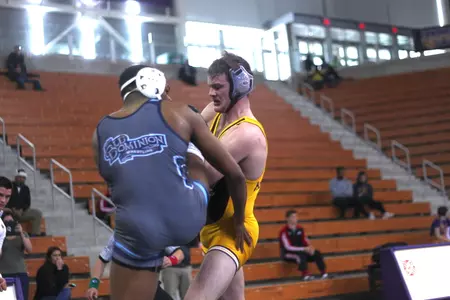 CMU's Colin Heffernan (right) battles with Larry Early during a 157-pound match Saturday during Day 1 of the MAC Championships at Northern Iowa's McLeod Center.