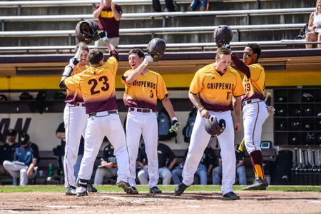 CMU's Robert Greenman (23) is greeted at the plate by teammates after his first-inning grand slam on Saturday at Theunissen Stadium.