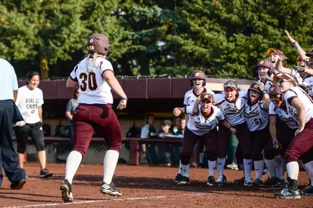 With her elated teammates waiting to greet her at the plate, CMU's Erika Underwood (30) completes her home-run trot on Wednesday at Margo Jonker Stadium.