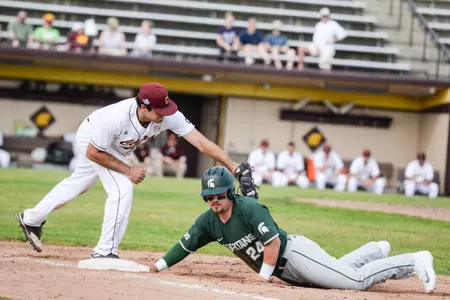 CMU first baseman Nick Stokowski (left) tags Chad Roskelly Tuesday during MSU's 7-0 nonconference win over the Chippewas at Theunissen Stadium.