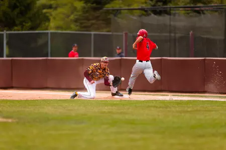 CMU first baseman Evan Kratt (left) awaits the throw to get Ball State's Jeff Riedel during Saturday's game at Theunissen Stadium.