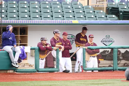 The Central Michigan coaching staff (from left) Tyler McFarland, Doug Sanders, Steve Jaksa and Jeff Opalewski, look on from the Sprenger Stadium dugout Thursday during CMU's 16-5 win over Western Michigan at the MAC Tournament.