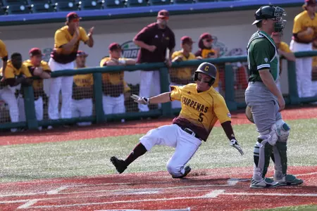 CMU's Zach Gilles slides in safely at home on Saturday during CMU's 4-2 loss to Eastern Michigan in the MAC Tournament in Avon, Ohio.