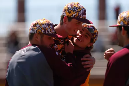 Tyler Hankins (center) gets hearty congratulations from teammates Sunday as he leaves the game with two outs in the ninth inning of a 3-1 win over Northern Illinois at Theunissen Stadium.