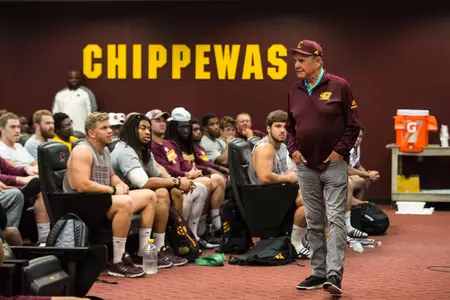Dick Enberg addresses CMU football players before Thursday's practice.