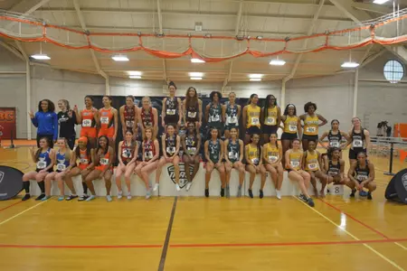 Members of the CMU women's 4x400 relay team pose, front and center, on the podium after winning their event on Saturday at the Mid-American Conference Indoor Track & Field Championships.