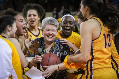 Sue Guevara, who is in her 11th year in charge of the CMU women's basketball program, is surrounded by her players Wednesday after the Chippewas' 88-80 victory at McGuirk Arena over Ball State.