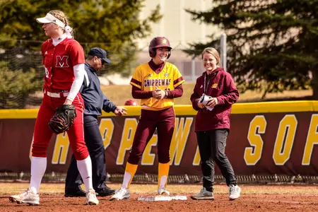 Freshman Shaidan Knapp shares a smile with first-base coach Brittney Horan during the Chippewas' sweep of Miami (Ohio) on Friday at Margo Jonker Stadium.