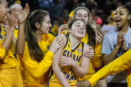 CMU junior guard Presley Hudson is congratulated by teammates as she was presented a game ball after CMU's home victory last week over Ball State.