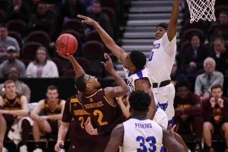 CMU guard Shawn Roundtree Jr. (left) goes up for a shot on Thursday in the Chippewas' MAC Tournament quarterfinal loss to Buffalo at Quicken Loans Arena in Cleveland.