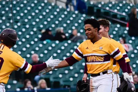 CMU junior Daniel Robinson receives congratulations from teammates after his two-run homer in the third inning Wednesday in the Chippewas' 16-3 win over Oakland at the annual Clash at Comerica.