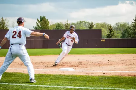 CMU third base coach Doug Sanders (24) waves home Daniel Robinson on Tuesday in the Chippewas' 13-2 nonleague victory over Michigan State. The Chippewas open a three-game MAC series on Thursday at home against Ohio.