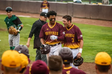 Zach Heeke (right) congratulates Daniel Robinson after Robinson's two-run homer in the eighth inning put the Chippewas ahead for good in their 4-2 win on Saturday over Ohio.