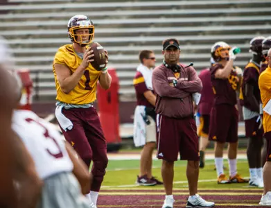 Quarterback Tony Poljan (left) works out under the watchful eye of second-year offensive coordinator/quarterbacks coach Chris Ostrowsky.