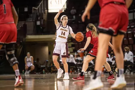 Molly Davis pointing with basketball in hand
