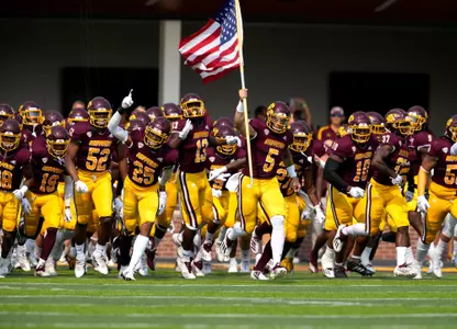 Team Running With Flag Signing Day