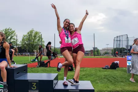 Hayley Manners, Sarah Daniel pose on the podium after third and fifth-place finishes in the MAC Long Jump Championship