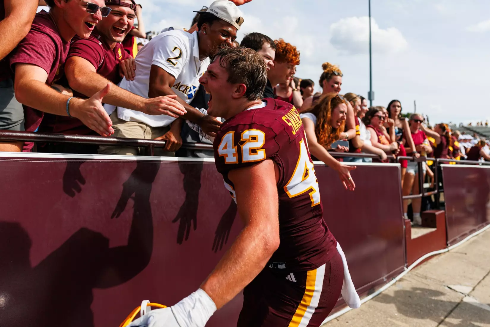 Landon Swanson (#42) celerates with student section after a Central Michigan win against Colgate football on Saturday Sept. 12, 2026 in Mount Pleasant. (Ty Klopf/Central Michigan Football)