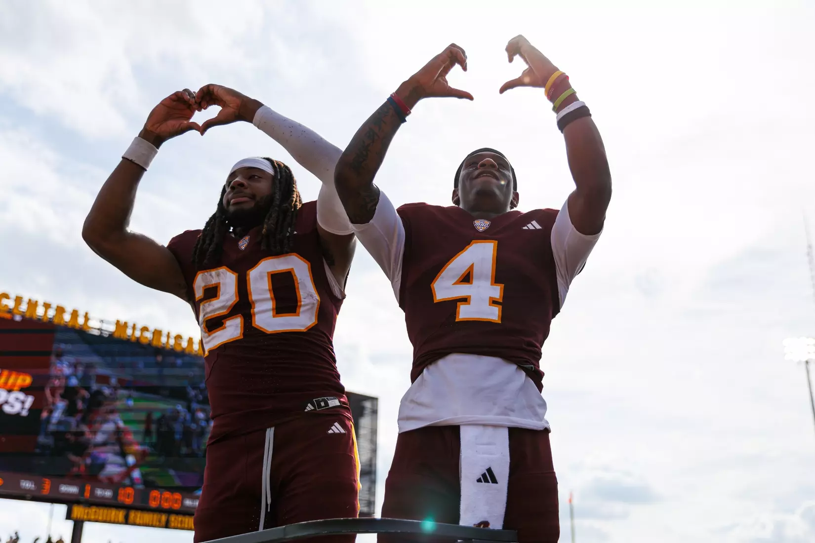 Langston Lewis (#20) and Jaion Jackson (#4) signal towards the Central Michigan marching band after a Central Michigan win against Colgate football on Saturday Sept. 12, 2026 in Mount Pleasant. (Ty Klopf/Central Michigan Football)