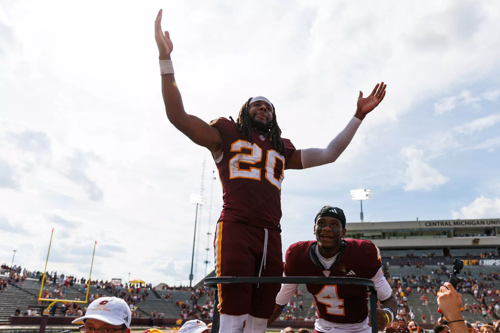 Langston Lewis (#20) celerates with the Central Michigan marching band after a Central Michigan win against Colgate football on Saturday Sept. 12, 2026 in Mount Pleasant. (Ty Klopf/Central Michigan Football)