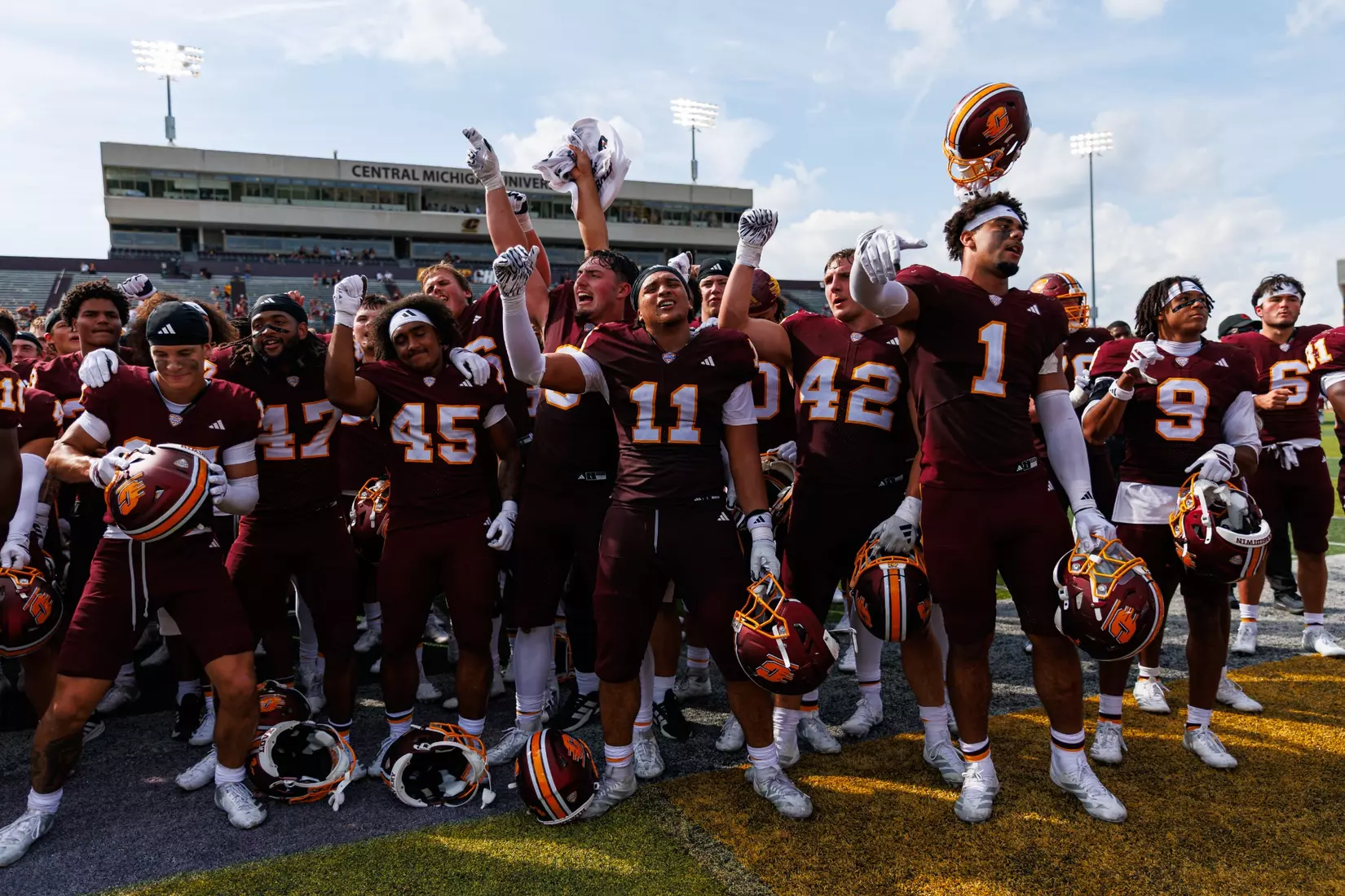 Team celerates with the Central Michigan marching band after a Central Michigan win against Colgate football on Saturday Sept. 12, 2026 in Mount Pleasant. (Ty Klopf/Central Michigan Football)