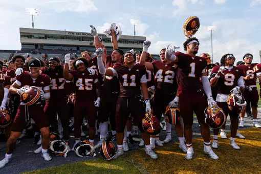 Team celerates with the Central Michigan marching band after a Central Michigan win against Colgate football on Saturday Sept. 12, 2026 in Mount Pleasant. (Ty Klopf/Central Michigan Football)