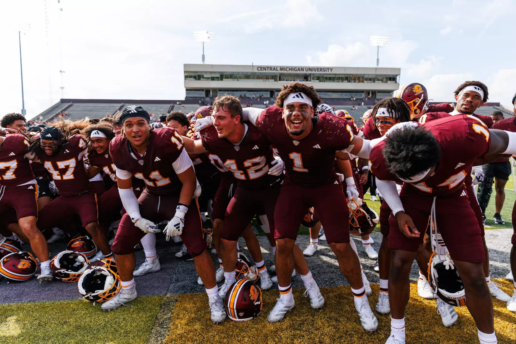 Team celerates with the Central Michigan marching band after a Central Michigan win against Colgate football on Saturday Sept. 12, 2026 in Mount Pleasant. (Ty Klopf/Central Michigan Football)
