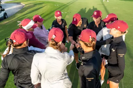 women's golf team huddle