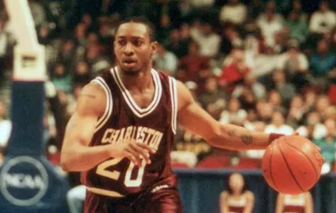 Jermel President dribbles the basketball as a Cougar