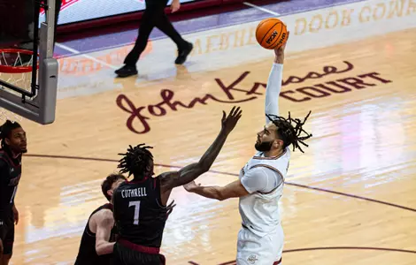 Christian Reeves shotos the ball over defender