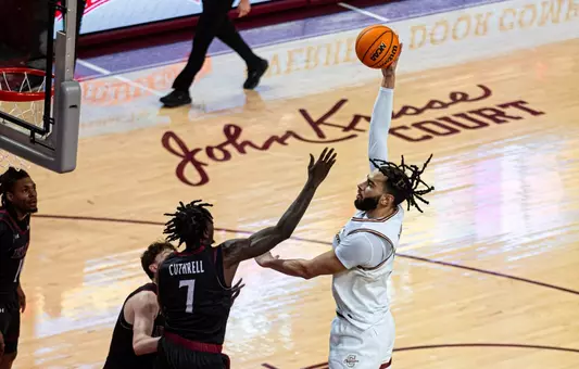 Christian Reeves shotos the ball over defender