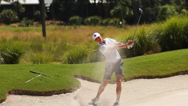 Jack Cook shooting a ball out of a bunker.