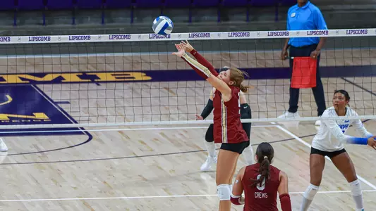Lainee Mack setting a volleyball.