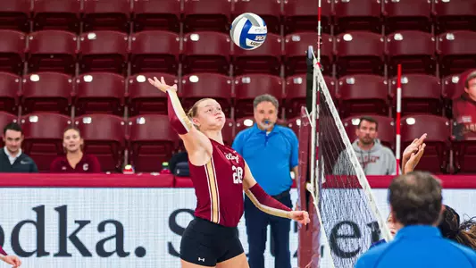 Lucy Haywood attacking a volleyball.
