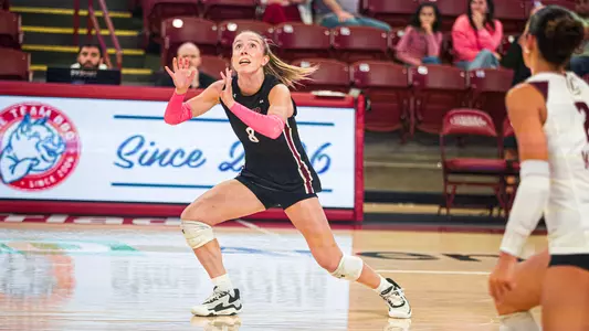 Sydney Bates awaiting to set a volleyball.