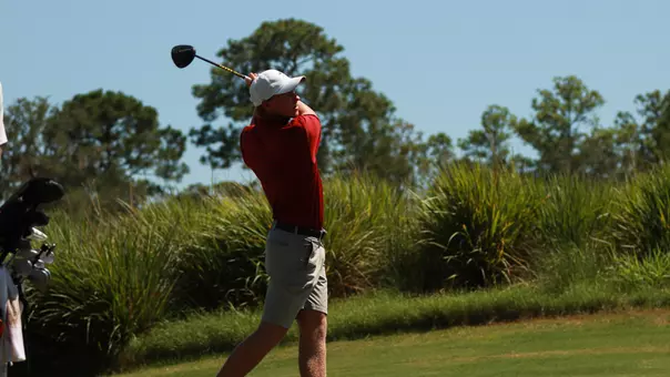 Jules Lauer teeing off at a hole.