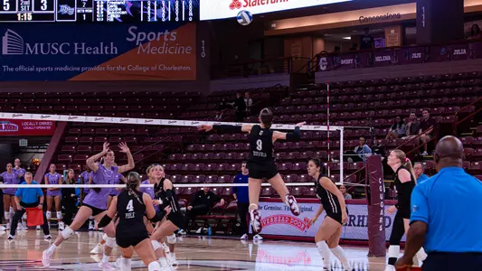 Emma Duffield jumping to hit a volleyball.