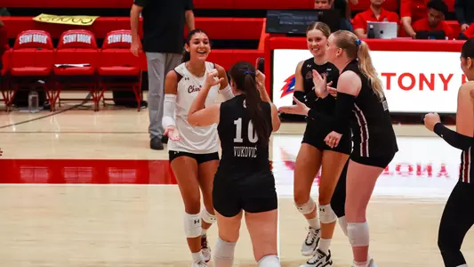 JuJu Martin celebrating a point with teammates.